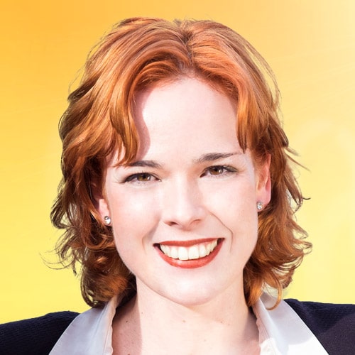 A woman with red hair smiling at the camera