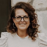 A woman with glasses and a striped shirt